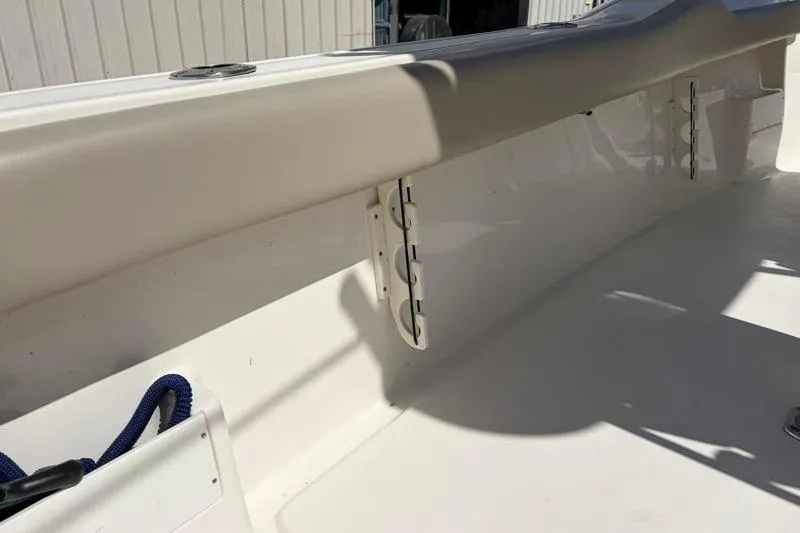 Slide: The Image of 2024 Key West 239 FS boat interior detail with rod holders and clean white finish. - 37