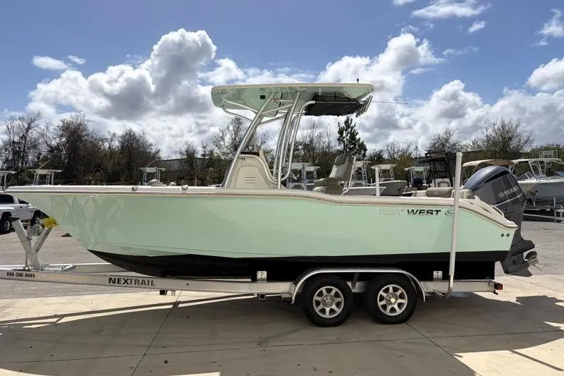 Slide: The Image of 2024 Key West 239 FS boat on trailer under cloudy sky. - 5
