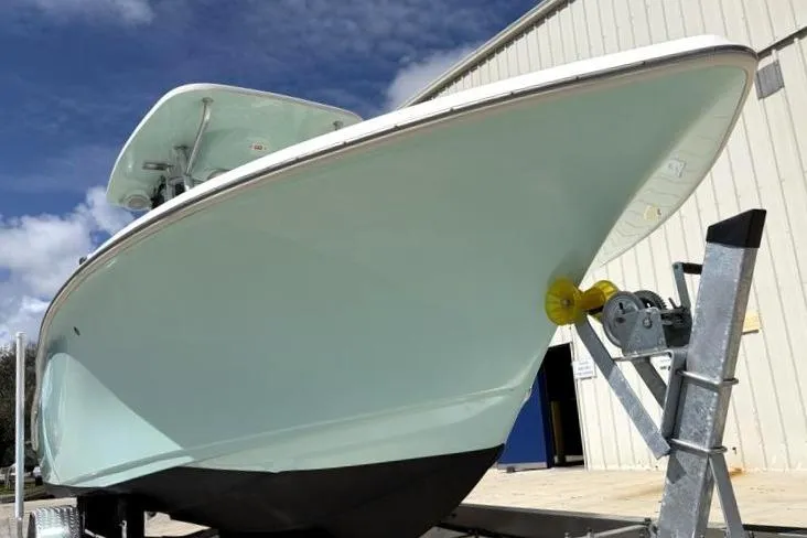 Slide: The Image of 2024 Key West 239 FS boat on trailer, viewed from the front, against a blue sky. - 9