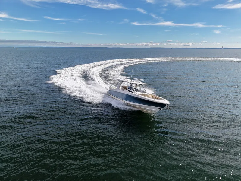 Slide: The Image of A 2027 Boston Whaler 350 Realm speeds across open water, leaving a large wake behind. - 4