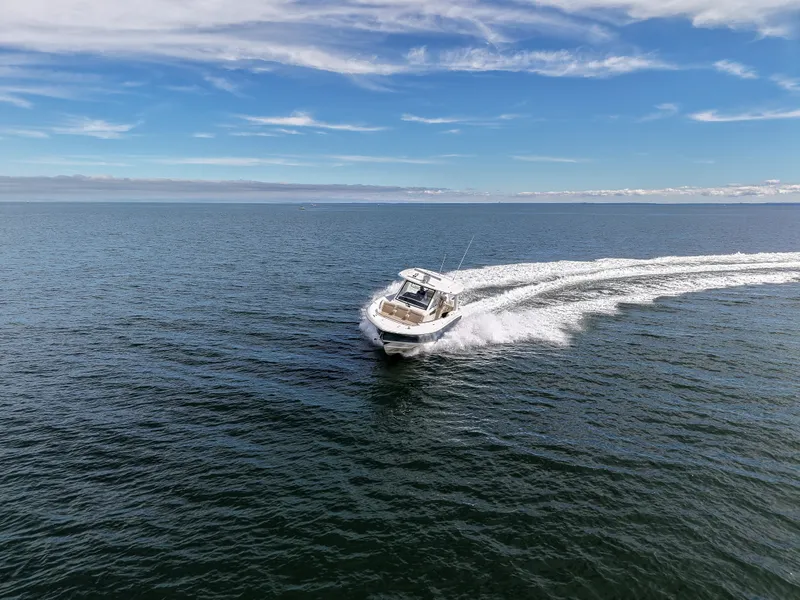 Slide: The Image of A 2027 Boston Whaler 350 Realm speeding across the open sea. - 3