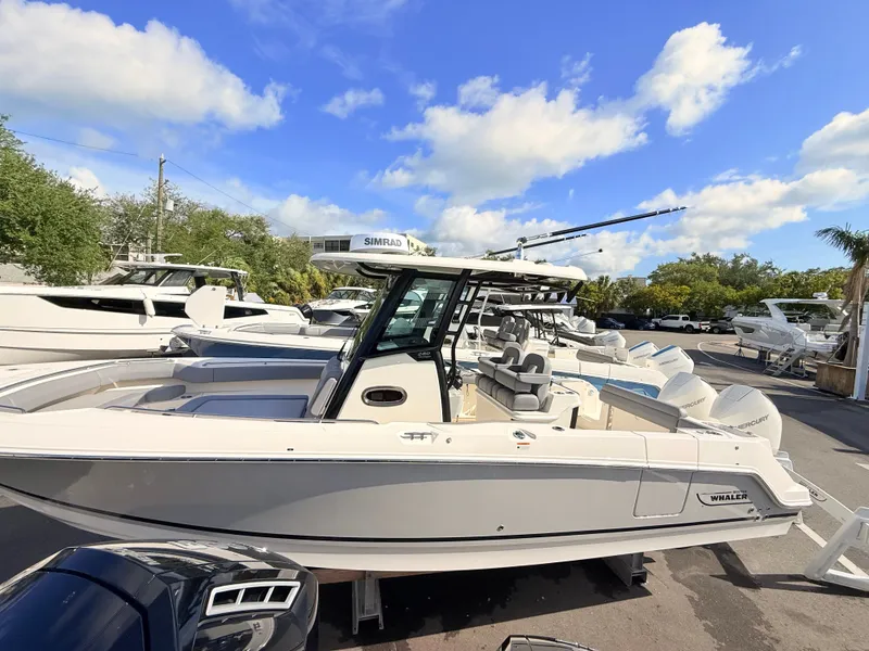 Slide: The Image of A 2026 Boston Whaler 280 Outrage with sleek design, spacious deck, and powerful outboard engines. - 11