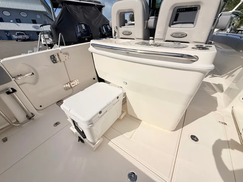 Slide: The Image of The image shows the cockpit of a Boston Whaler 280 Outrage with a white seat and helm console. - 26