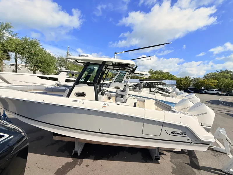 Slide: The Image of A 2026 Boston Whaler 280 Outrage on a trailer. It features a sleek, modern design. - 9