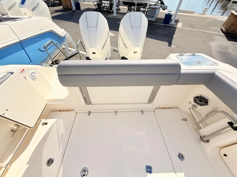 Slide: The Image of The image shows the stern of a Boston Whaler 280 Outrage with two Mercury outboard engines. - 15