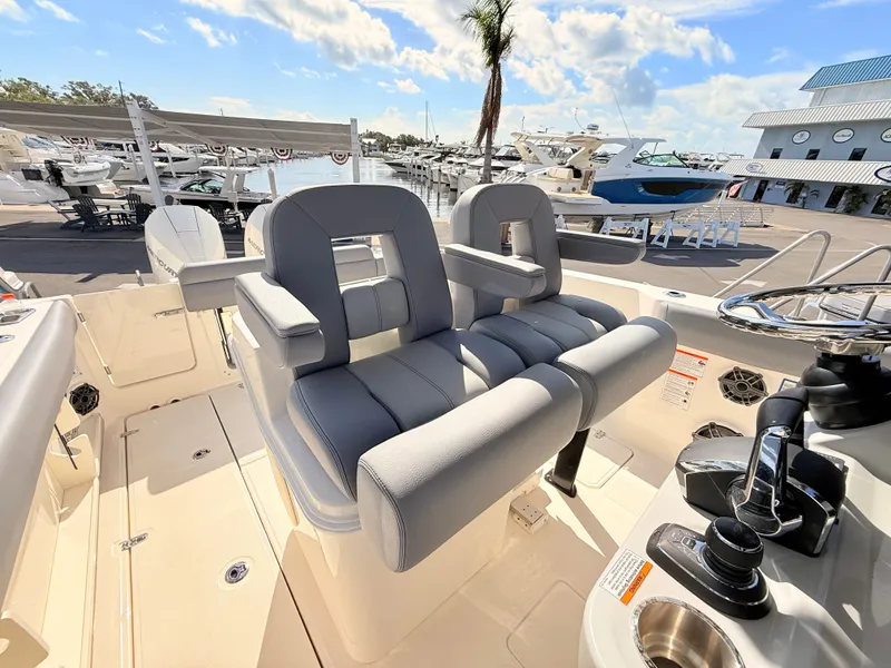 Slide: The Image of The 2026 Boston Whaler 280 Outrage features luxurious, cushioned seating in the cockpit area of a modern boat. - 33