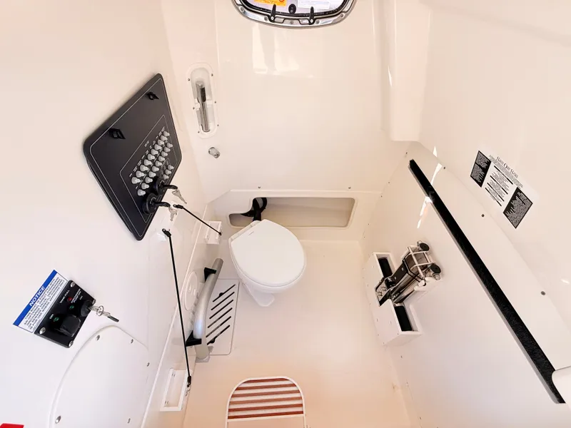 Slide: The Image of Interior view of a boat cabin with a toilet and control panel. - 45