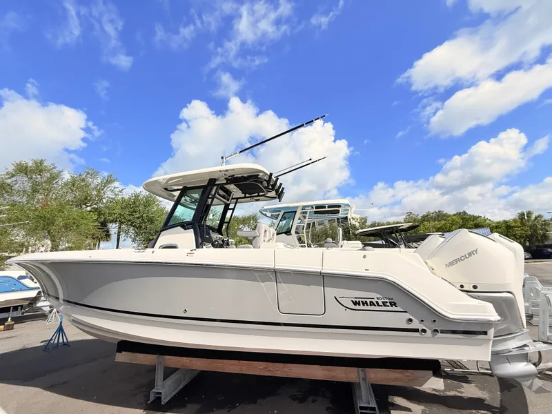 Slide: The Image of Boston Whaler 280 Outrage 2026 on a trailer under a blue sky. - 0