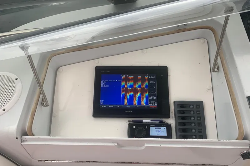 Slide: The Image of Control panel of a 1999 Hatteras 52 Cockpit Motor Yacht with Garmin display. - 10