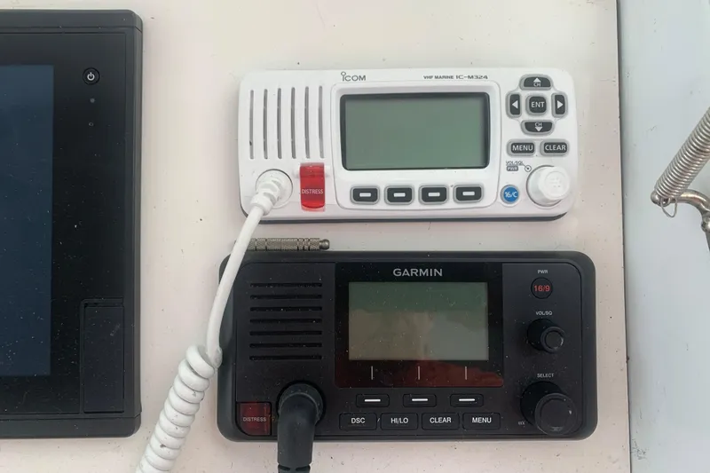 Slide: The Image of VHF marine radios on a 1999 Hatteras 52 Cockpit Motor Yacht dashboard. - 13