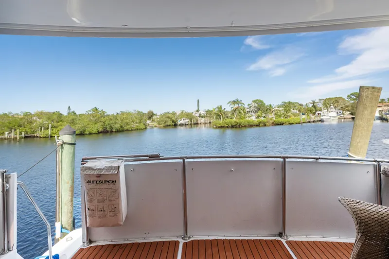 Slide: The Image of Hatteras 52 Cockpit Motor Yacht 1999, scenic water view from deck, clear blue sky. - 19