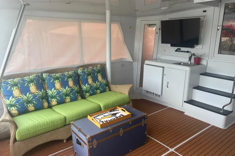 Slide: The Image of Interior of 1999 Hatteras 52 Cockpit Motor Yacht with tropical decor and modern amenities. - 20