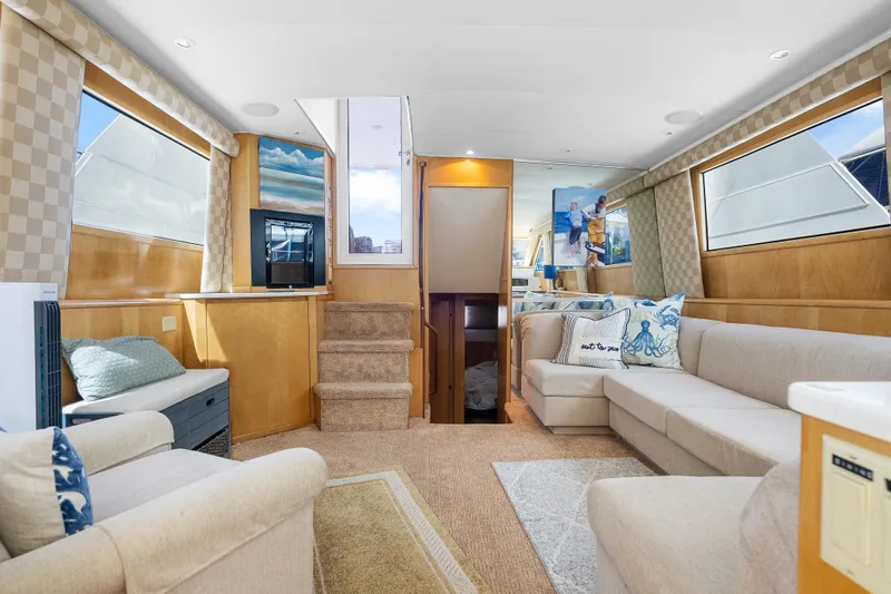 Slide: The Image of Luxurious interior of 1999 Hatteras 52 Cockpit Motor Yacht with elegant seating and decor. - 21