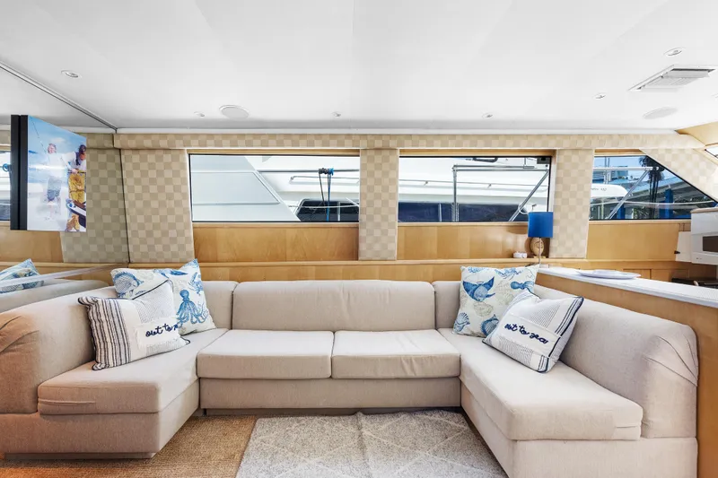 Slide: The Image of Luxurious interior of 1999 Hatteras 52 Cockpit Motor Yacht with elegant beige sofa. - 22