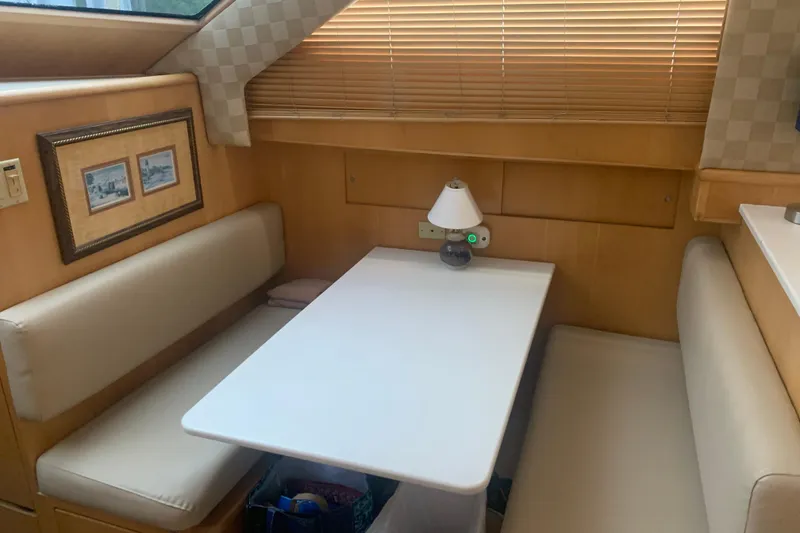 Slide: The Image of Interior of 1999 Hatteras 52 Cockpit Motor Yacht with cozy dining area. - 24