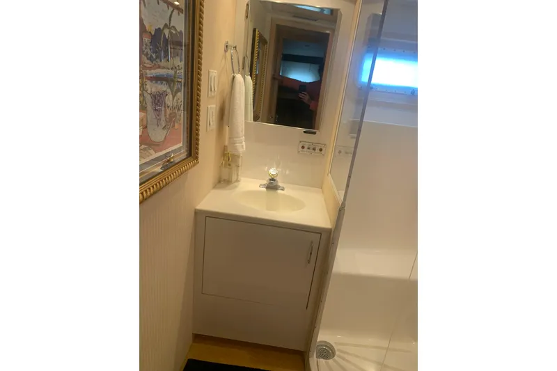 Slide: The Image of Bathroom interior of 1999 Hatteras 52 Cockpit Motor Yacht with sink and mirror. - 26