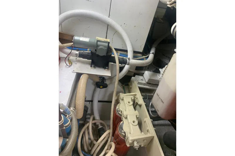 Slide: The Image of Engine room of 1999 Hatteras 52 Cockpit Motor Yacht with hoses and machinery. - 37