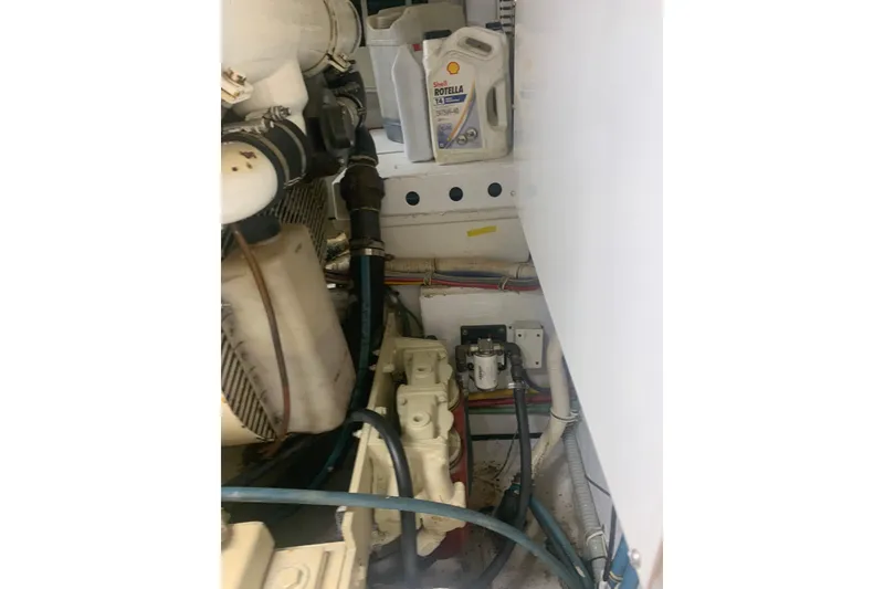 Slide: The Image of Engine room of 1999 Hatteras 52 Cockpit Motor Yacht with oil container and wiring. - 38