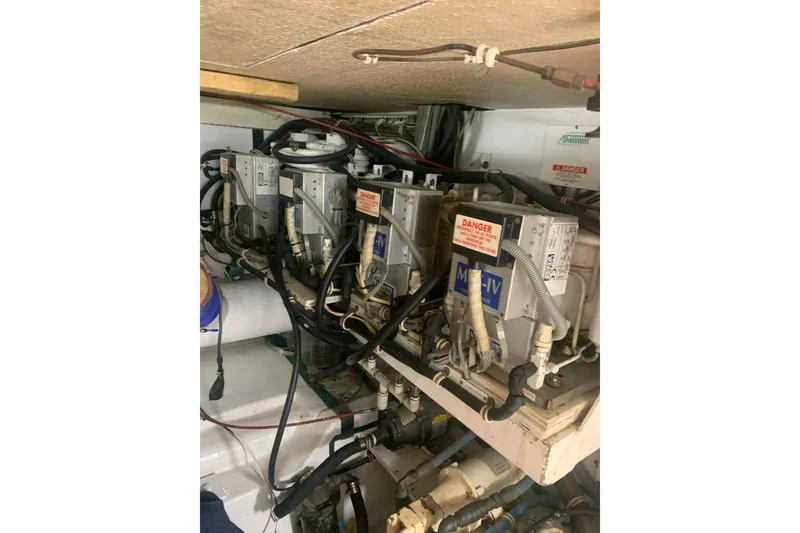 Slide: The Image of Engine room of 1999 Hatteras 52 Cockpit Motor Yacht with mechanical components. - 39