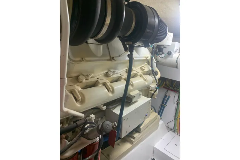 Slide: The Image of Engine room of 1999 Hatteras 52 Cockpit Motor Yacht with visible components and wiring. - 40