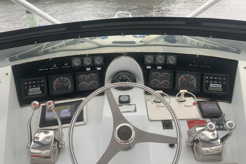 Slide: The Image of Cockpit view of 1999 Hatteras 52 Cockpit Motor Yacht with steering wheel and control panel. - 7