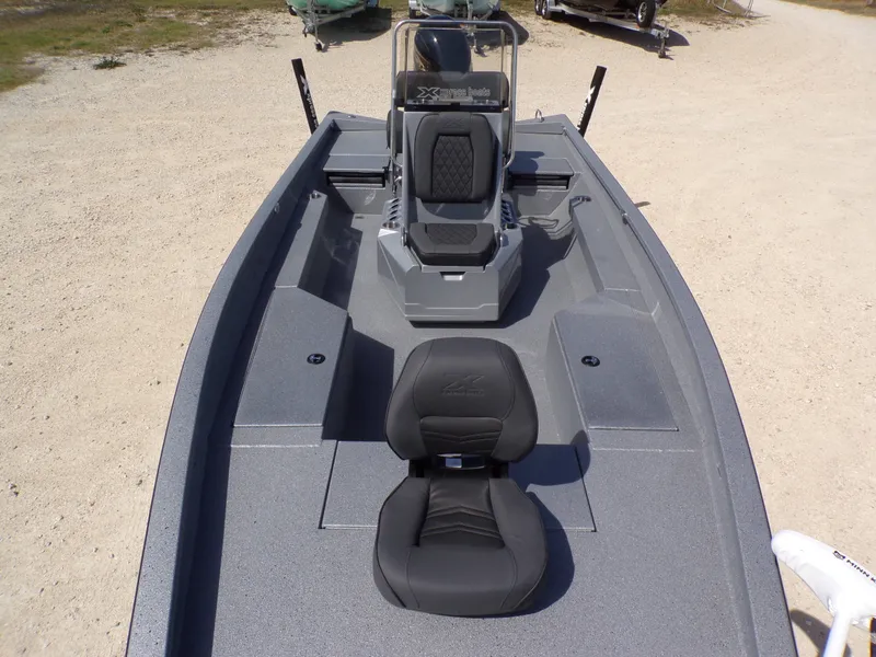 Slide: The Image of 2026 Xpress H22B Bay boat with gray seats and console. - 24
