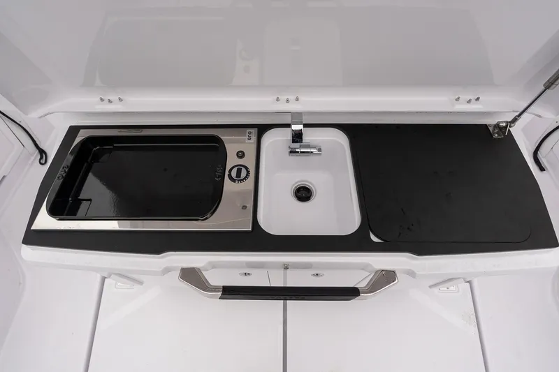 Slide: The Image of 2027 Axopar 38 Cross Cabin kitchen area with sink and stove. - 12