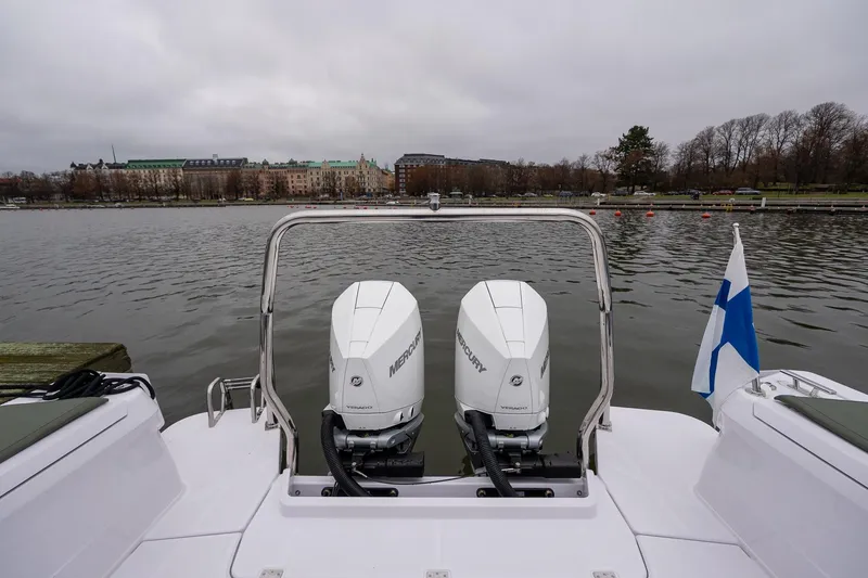 Slide: The Image of 2027 Axopar 38 Cross Cabin with dual Mercury engines on a lake. - 17