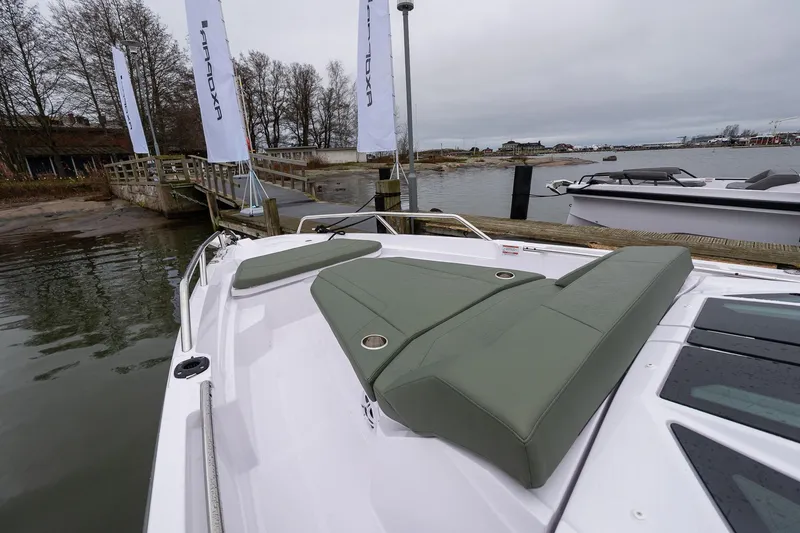 Slide: The Image of 2027 Axopar 38 Cross Cabin boat docked, featuring sleek design and comfortable seating. - 26