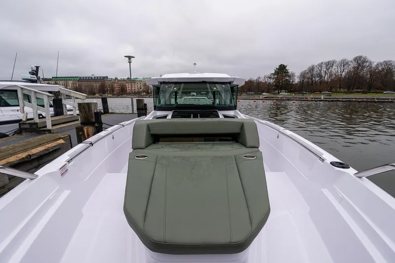 Slide: The Image of 2027 Axopar 38 Cross Cabin boat docked, featuring sleek design and spacious deck. - 27