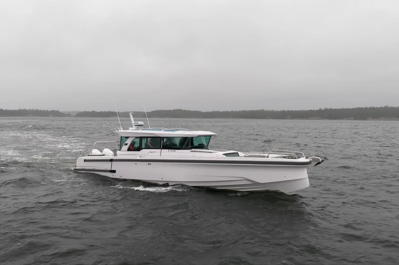 Slide: The Image of 2027 Axopar 38 Cross Cabin boat cruising on a cloudy day. - 3