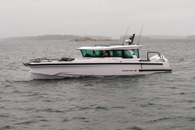 Slide: The Image of 2027 Axopar 38 Cross Cabin boat on a cloudy day at sea. - 5