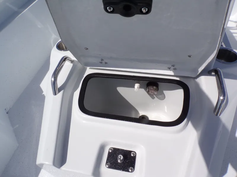 Slide: The Image of Open storage compartment on a 2026 Xpress SW20B boat. - 23