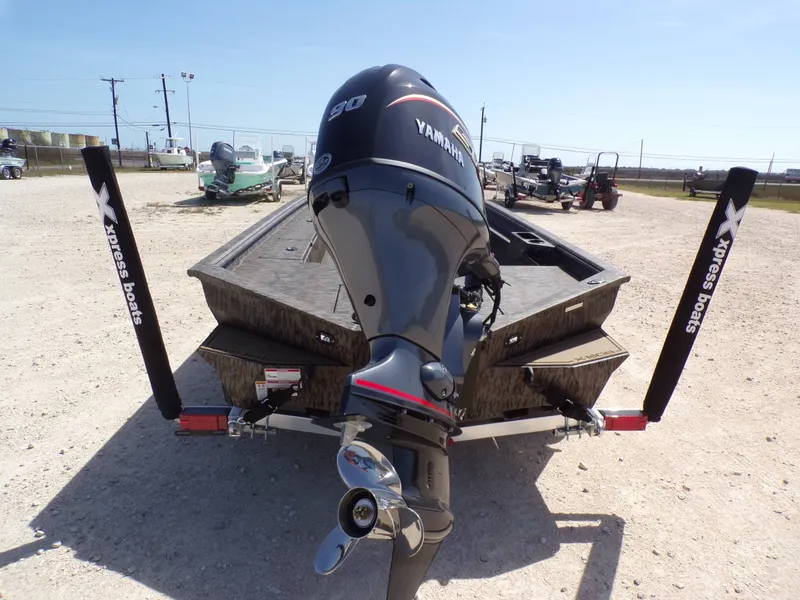 Slide: The Image of Rear view of 2026 Xpress X18DB boat with Yamaha engine. - 12