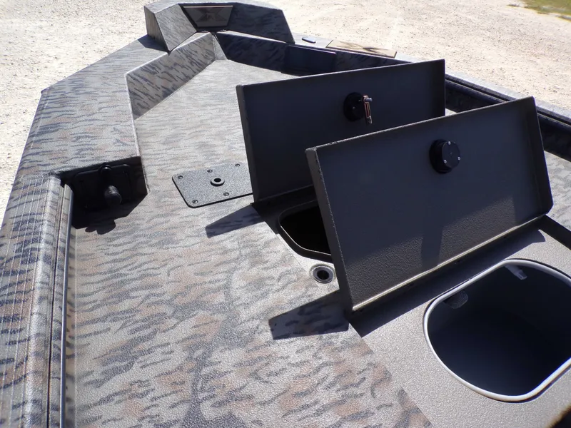 Slide: The Image of 2026 Xpress X18DB boat with open storage compartments. - 18