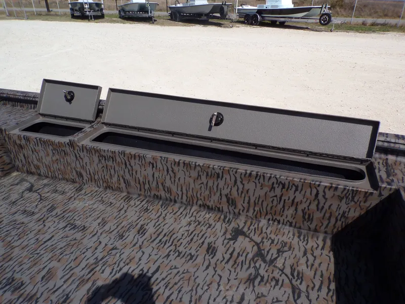 Slide: The Image of 2026 Xpress X18DB boat with storage compartment lids. - 23