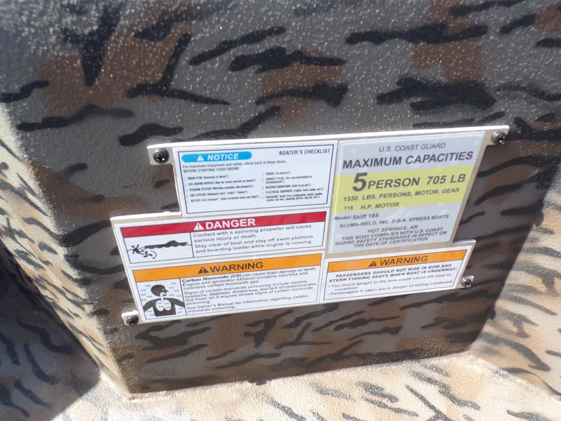 Slide: The Image of Warning and capacity label on Xpress X18DB boat. - 26