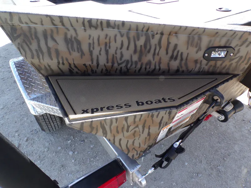 Slide: The Image of 2026 Xpress X18DB boat with camouflage pattern and trailer. - 5