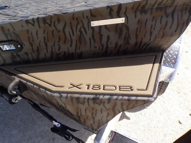 Slide: The Image of 2026 Xpress X18DB boat with camouflage pattern and model label. - 6