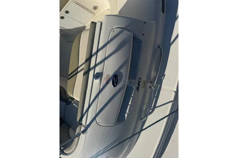 Slide: The Image of 2005 Sea Ray 240 Sundeck boat interior with seating and storage compartments. - 13