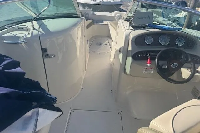 Slide: The Image of 2005 Sea Ray 240 Sundeck interior with steering wheel and dashboard, featuring Garmin equipment. - 12