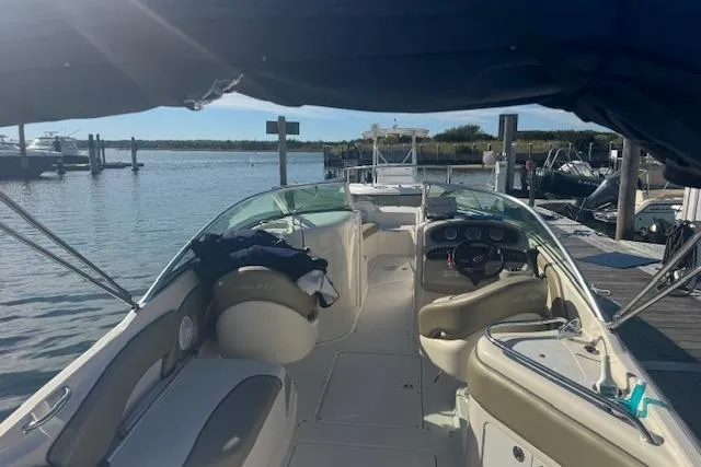 Slide: The Image of 2005 Sea Ray 240 Sundeck boat docked at a marina, interior view. - 14