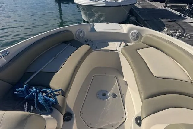 Slide: The Image of 2005 Sea Ray 240 Sundeck boat interior with beige seating and blue rope. - 4
