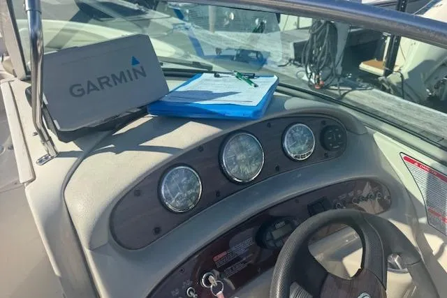 Slide: The Image of 2005 Sea Ray 240 Sundeck dashboard with Garmin GPS and gauges. - 9