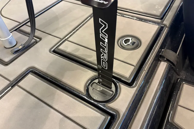 Slide: The Image of 2026 Nitro Z19 XL boat deck with storage compartments and branded pole. - 19