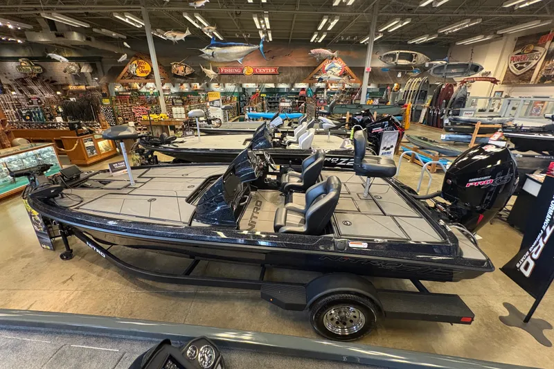 Slide: The Image of 2026 Nitro Z19 XL boat displayed in a fishing store showroom. - 7