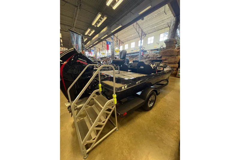 Slide: The Image of 2026 Nitro Z19 XL boat displayed indoors with metal steps and powerful engine. - 4