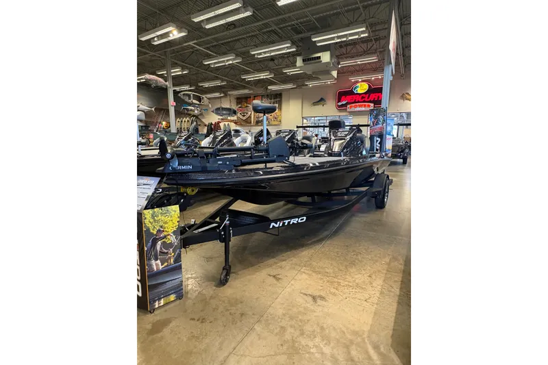 Slide: The Image of 2026 Nitro Z19 XL boat displayed in a showroom with fishing equipment. - 8