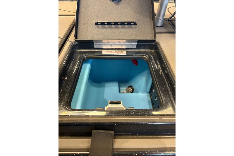 Slide: The Image of Open storage compartment in 2026 Nitro Z19 XL boat, featuring a blue interior. - 21