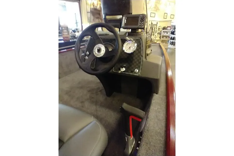 Slide: The Image of 2026 Tracker Bass Tracker Classic XL boat dashboard with steering wheel and gauge. - 11